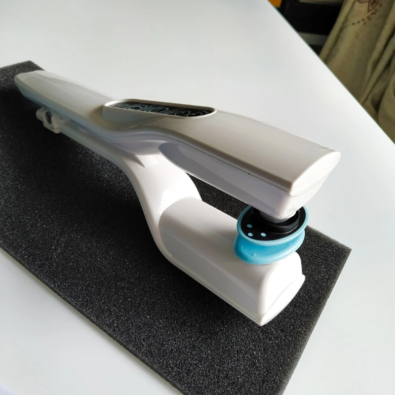 White reflex stimulator base with blue pad head on a black stand