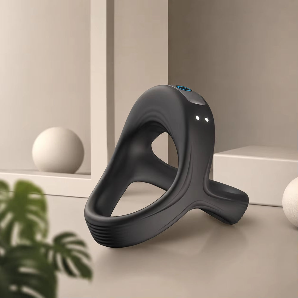 Black silicone ring massager with curved open design and small blue indicator